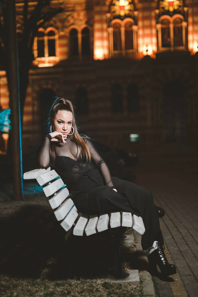 A portrait of a young female wearing a sexy black outfit - Fotografie, Obrázek