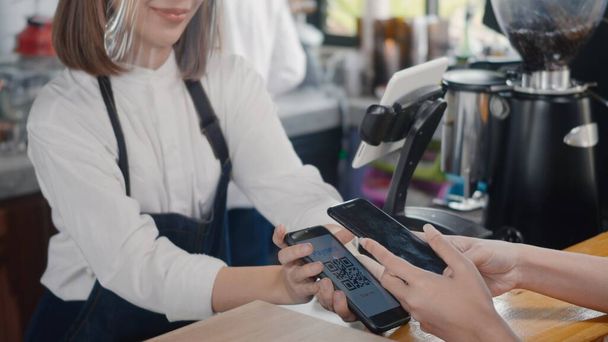 QR code payment, customer woman using digital smartphone application scanning QR code payment without money for buying coffee in cafe coffee shop, small business accepts digital payment - Photo, Image