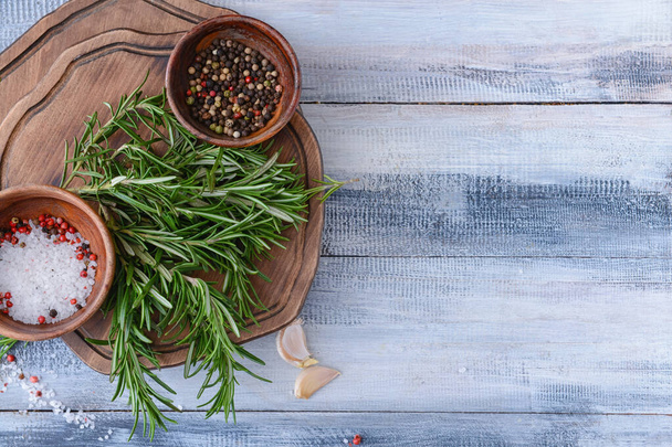 Composition with fresh rosemary and spices on wooden background - 写真・画像