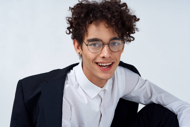 portrait of a curly-haired guy in a shirt in a jacket and glasses  - Valokuva, kuva