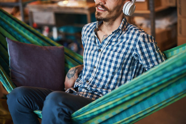 Joyful young man listening to music at home - Photo, image