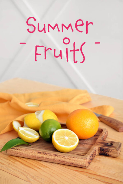 Board with fresh citrus fruits on table - Фото, зображення