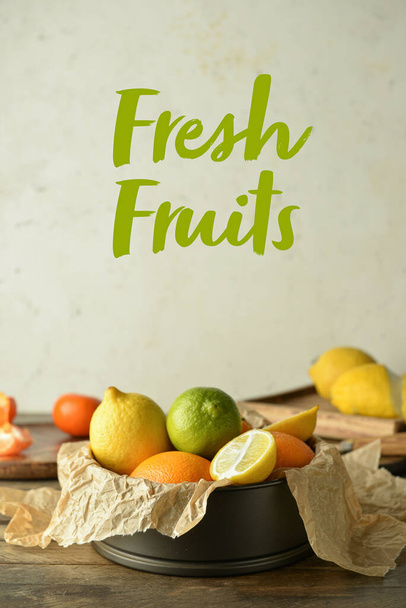 Box with fresh citrus fruits on table - Фото, зображення