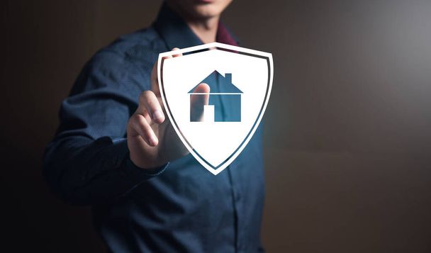 businessman pushing on a billboard with a house. Home safety - Photo, Image