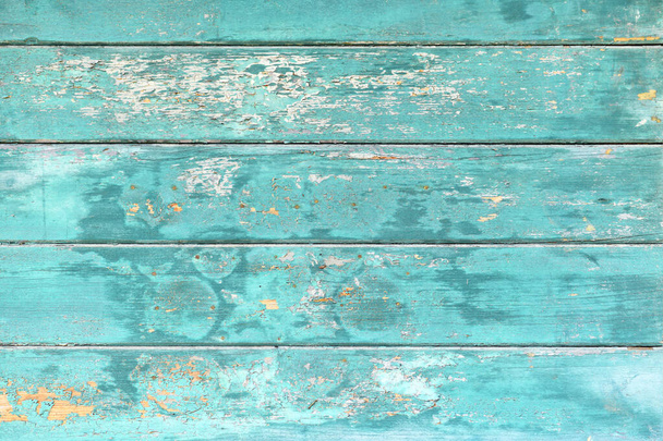 Background with wooden teal blue colored old weathered planks with chipped paint - Фото, изображение