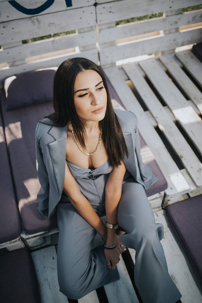 A high angle shot of a young female from Bosnia and Herzegovina in a trendy blue suit - Fotó, kép