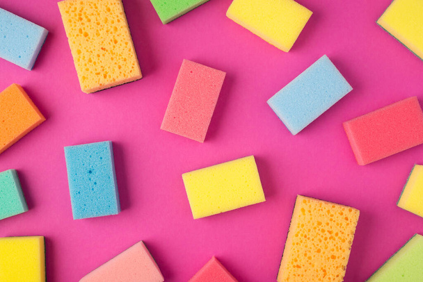 Top view photo of multicolor sponges on isolated pink background - Fotoğraf, Görsel