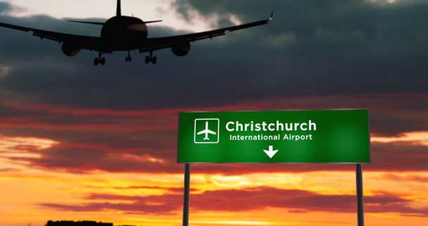 Avión silueta aterrizaje en Christchurch, Nueva Zelanda. Llegada a la ciudad con letrero de dirección del aeropuerto y puesta de sol en segundo plano. Concepto de viaje y transporte 3d ilustración. - Foto, imagen