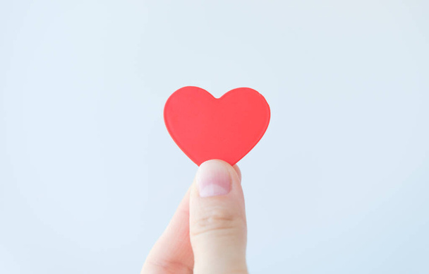 Female hand holding red heart. Organ donation, family insurance. World heart day, World health day, Gratitude, be kind, be thankful. Love concept. - Φωτογραφία, εικόνα