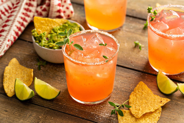 Spicy grapefruit margarita with chips and guacamole - 写真・画像