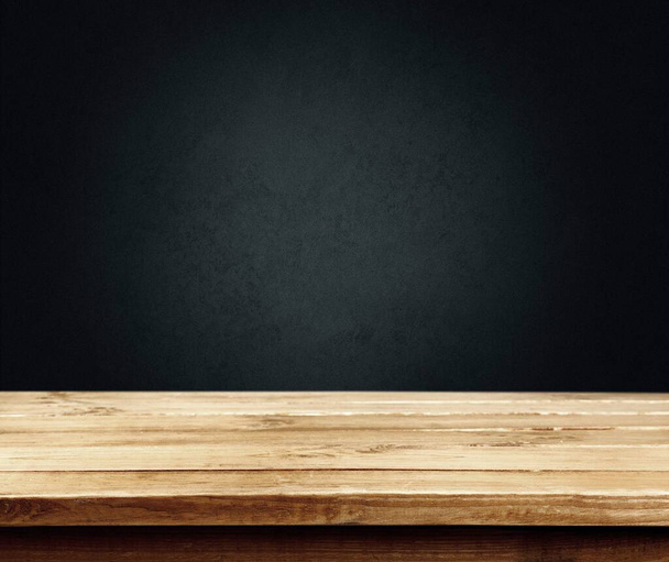 Wooden table top in dark room background concept for advertising. - Fotó, kép