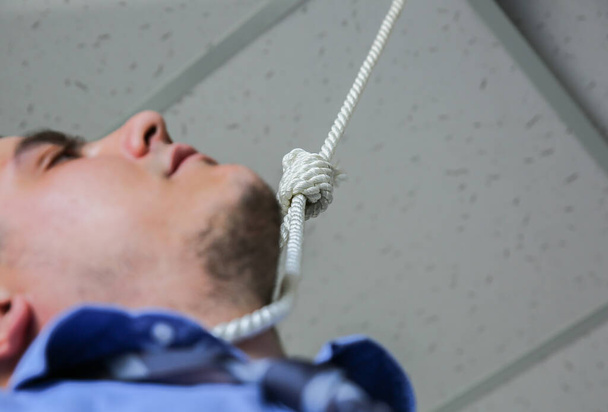 Office worker with noose around neck. Suicide concept. Hanging because of work stress. Depression of burnout. Terrible life situation. - Photo, Image