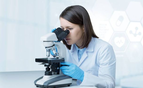 Science technology concept. Scientific examination. A scientist with a microscope - Zdjęcie, obraz