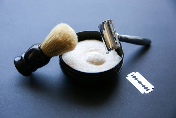 Shaving brush, razor and blade on the table. Stylish men set. idea for a gift. Barber shop things. - Photo, Image