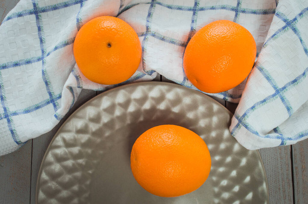 Fresh oranges on the table.Juicy fruit vitamins are a useful food for vegans. - Zdjęcie, obraz