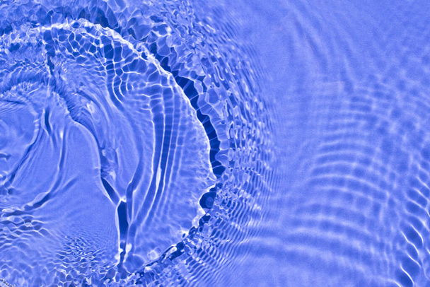 Water spills on a light blue background. - Photo, Image