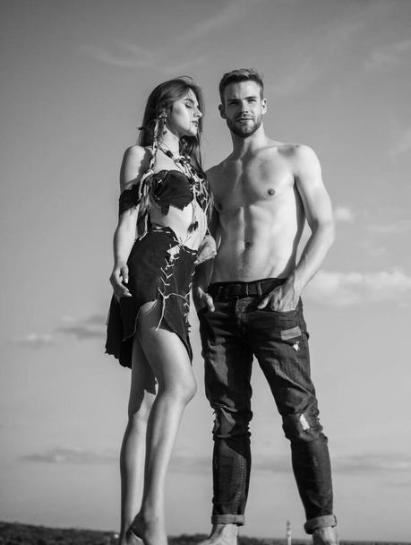 romantic relationship concept. hot summer weather. macho man has muscular body. sensual couple in love. sexy girl wear suede leather. primitive instinct. feel the desire - Fotoğraf, Görsel