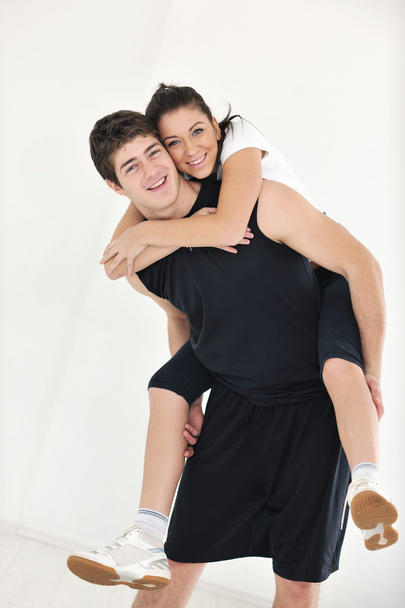 Happy young couple fitness workout and fun at sport gym club - Photo, Image