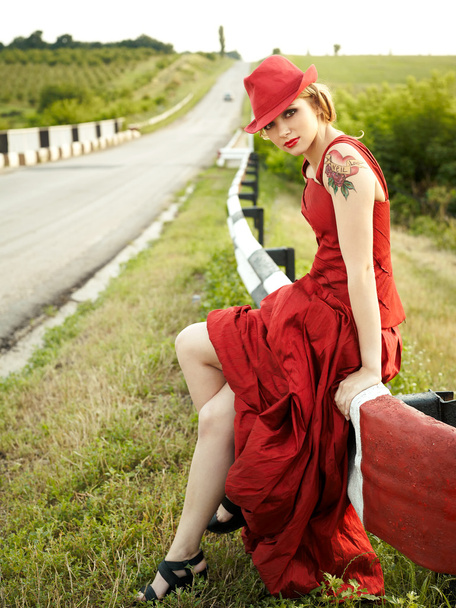 Woman in red dress near the freeway - Foto, imagen