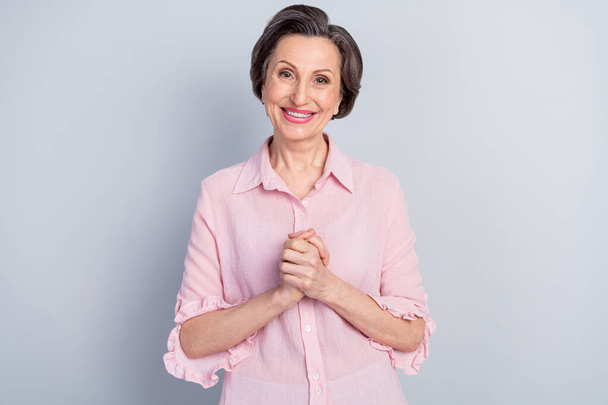 Photo of charming peaceful mature lady wear pink clothes smiling arms together chest isolated grey color background - Fotografie, Obrázek
