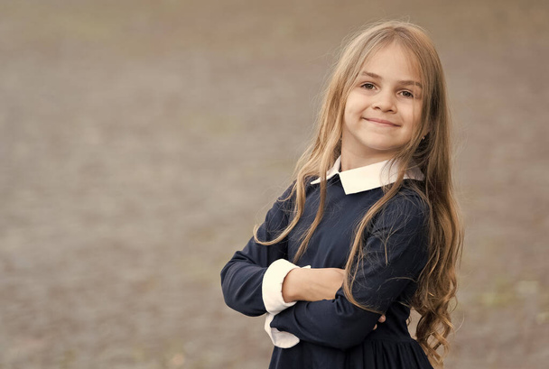 Confident beginner. Happy child wear uniform outdoors. Back to school look. School fashion. Beauty look. Early childhood education. Enjoying pupil life, copy space - Foto, immagini