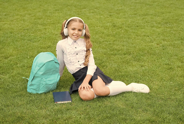 Be a good learner lifelong. teen girl with book on green grass. child little girl read book. study literature for children. new technology in digital life. knowledge day. future school education - Foto, Bild