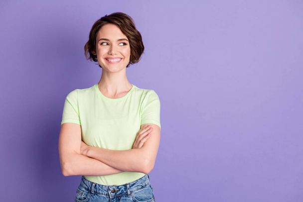 Portrait of attractive cheerful brown-haired girl looking aside copy blank space ad folded arms isolated over violet color background - Fotografie, Obrázek