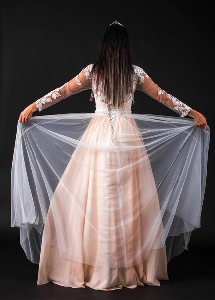 Full length studio portrait of young beautiful woman in long dress - Фото, зображення