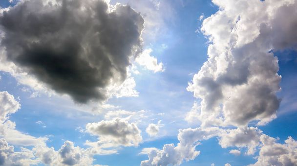 Blue sky with white plump fluffy clouds and sun. Cumulus clouds. Nature weather blue sky. Beautiful background white clouds. - Photo, Image