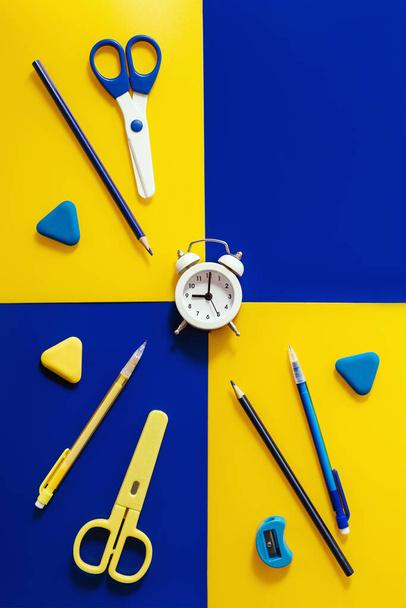 Creative layout with clock and stationary school supplies, alarm clock shows 9 oclock in morning, time to go to school concept. - Foto, immagini