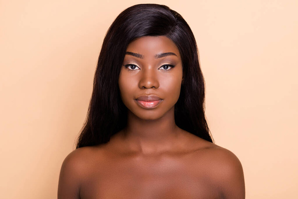 Photo of serious adorable dark skin nude woman silky smooth skin isolated beige color background - Φωτογραφία, εικόνα