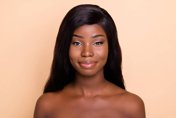 Photo of adorable smiling dark skin nude woman smooth fresh skin isolated beige color background - Foto, imagen
