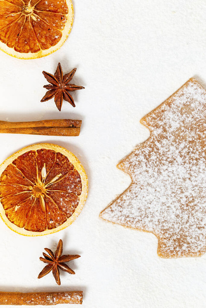 Fragrant Christmas cookies with cinnamon, anise, dried oranges on paper. New Year or Christmas theme. Flat lay, top view, copy space. - Foto, imagen