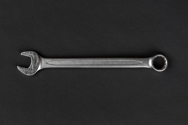 Wrench on black paper background - Foto, immagini