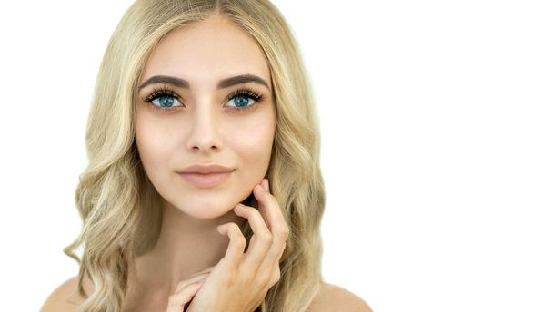 Beauty smiling blonde model with natural nude make up and long eyelashes. Skin care, Spa and wellness  concept. Make up, long hair and lashes. Close up, selective focus. - Φωτογραφία, εικόνα
