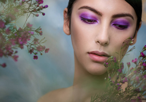 Beautiful young woman with perfect skin posing with flowers.  SPA, wellness, bodycare and skincare. - Fotoğraf, Görsel