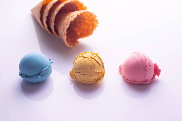 multicolored ice cream balls waffle cones on white background. - Фото, зображення