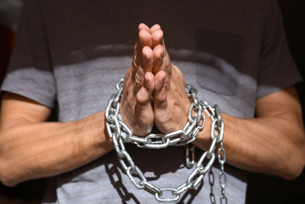 Male hostage with tied hands praying, closeup - Photo, Image