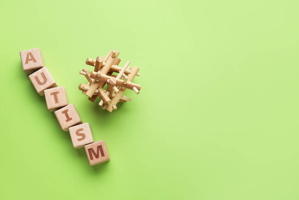 Word AUTISM and toy on color background - Photo, Image