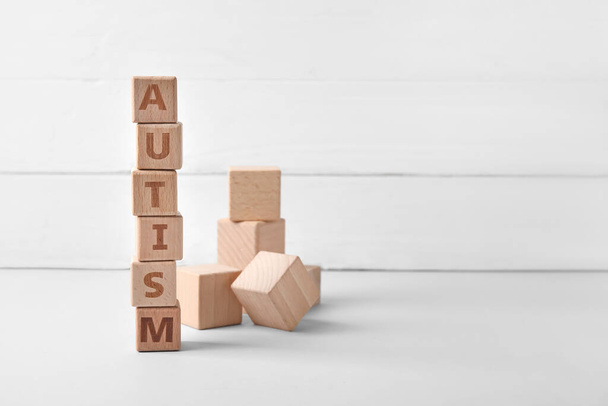 Word AUTISM made of cubes on white wooden background - Photo, Image