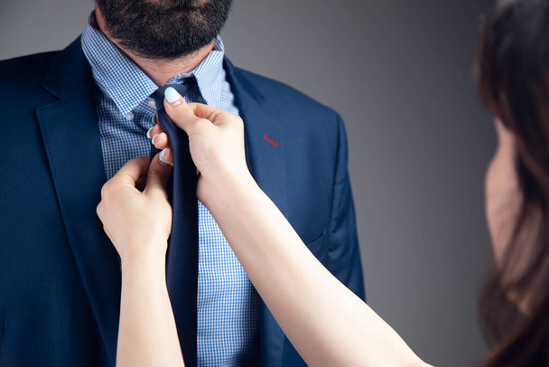 a woman straightens a man's suit - Foto, imagen