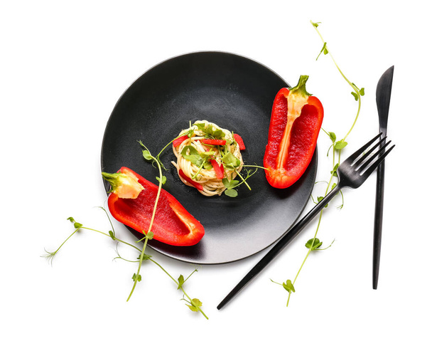 Plate with tasty pasta, bell pepper and microgreen on white background - Photo, Image
