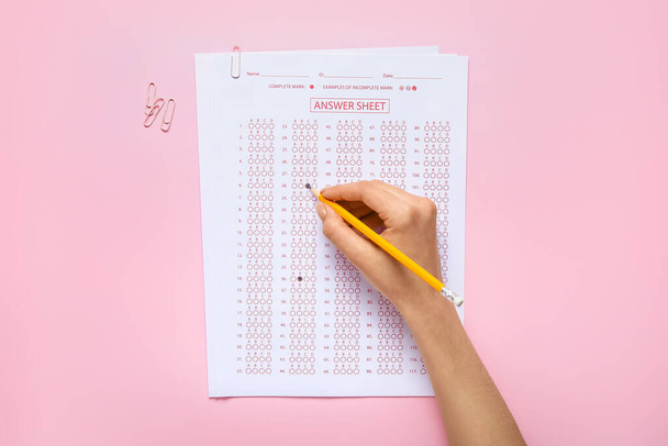 Student passing school test on color background - Fotó, kép