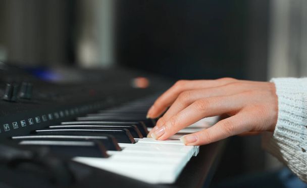 Girl playing piano. Close-up view. - Foto, immagini