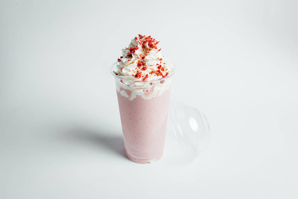 Стаканы свежего клубничного молочного коктейля, летний коктейль с ломтиком клубники на ярком фоне - Фото, изображение
