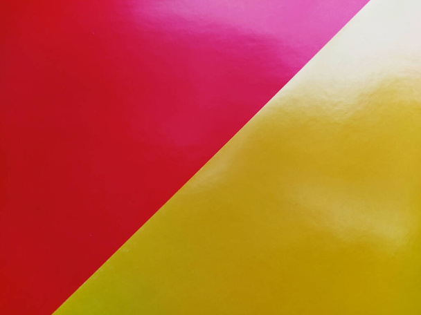 Yellow-pink bright background. Diagonally laid sheets of colored paper with a gradient and light flare. - Foto, Imagem