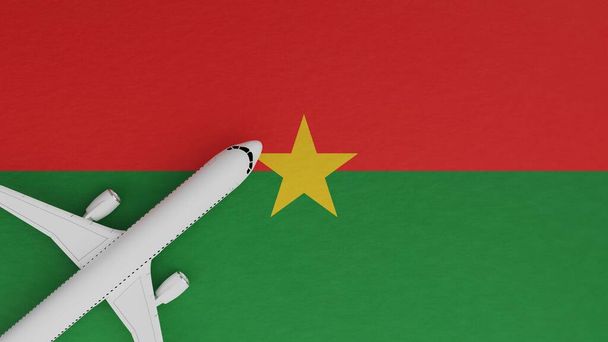 Vista de arriba hacia abajo de un avión en la esquina en la parte superior de la bandera del país de Burkina Faso - Foto, imagen