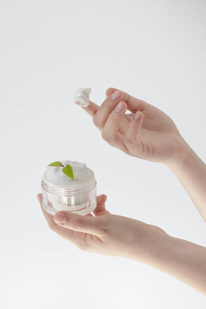 hand or face cream, beautiful female hands holding a jar of cream, concept of skin care, natural cosmetics, spa, massage, hydration and rejuvenation - Valokuva, kuva
