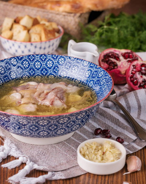 Caucasian soup khash with puri flat bread and greensKhash - dish of boiled cow's feet. traditional dish in Afghanistan, Azerbaijan, Bosnia and Hercegovina, Bulgaria, Georgia, Iran, Iraq, and - Photo, Image