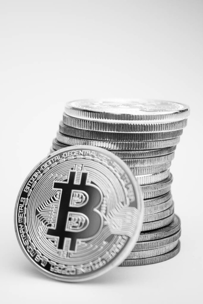 One silver bitcoin and stack of cryptocurrencies over white background - Photo, image